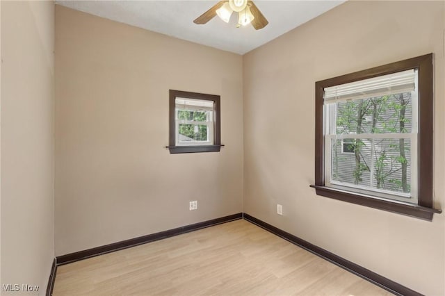 1540 Grand Park Ave, Akron, OH 44310 - unfurnished room with healthy amount of natural light, light wood-style floors, a ceiling fan, and baseboards