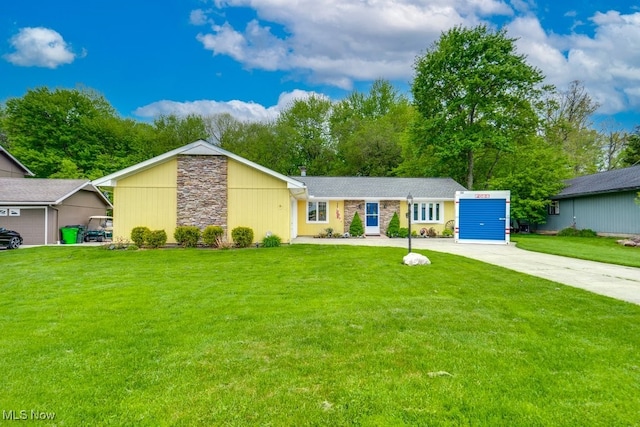 9942 Pebble Beach Cv, Reminderville, OH 44202 - view of front of house featuring concrete driveway, a front lawn, and stone siding