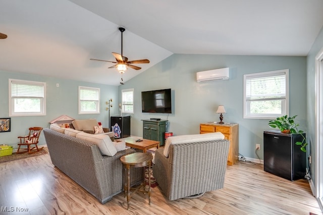 9942 Pebble Beach Cv, Reminderville, OH 44202 - living room with a wall unit AC, ceiling fan, light wood-type flooring, lofted ceiling, and baseboards