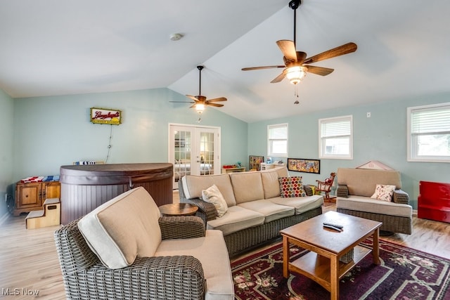 9942 Pebble Beach Cv, Reminderville, OH 44202 - living room with light wood finished floors, healthy amount of natural light, a ceiling fan, french doors, and vaulted ceiling