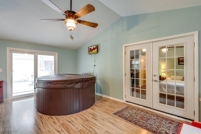 9942 Pebble Beach Cv, Reminderville, OH 44202 - bar with french doors, vaulted ceiling, wood finished floors, a ceiling fan, and baseboards