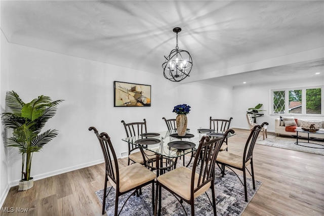 2162 Daniels Ave, Akron, OH 44312 - dining area with light wood-type flooring, baseboards, and a chandelier