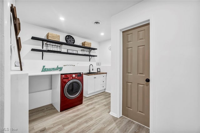 2162 Daniels Ave, Akron, OH 44312 - clothes washing area featuring cabinet space, washer / dryer, bar with sink, light wood-type flooring, and recessed lighting