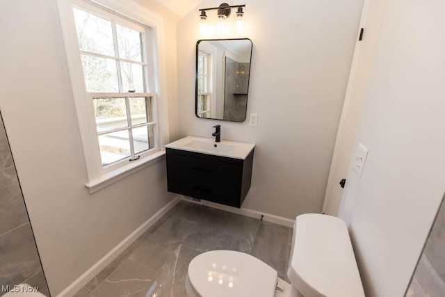 half bath featuring baseboards, marble finish floors, toilet, and vanity