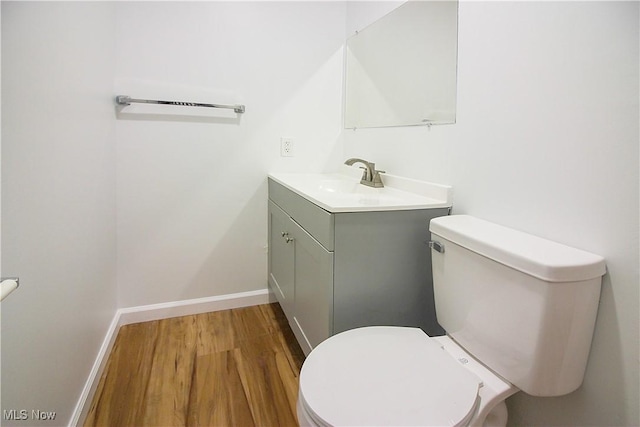 1335 Avalon Dr, Madison, OH 44057 - half bath featuring wood finished floors, toilet, vanity, and baseboards