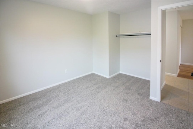 1335 Avalon Dr, Madison, OH 44057 - unfurnished bedroom featuring carpet floors, baseboards, a closet, and tile patterned flooring