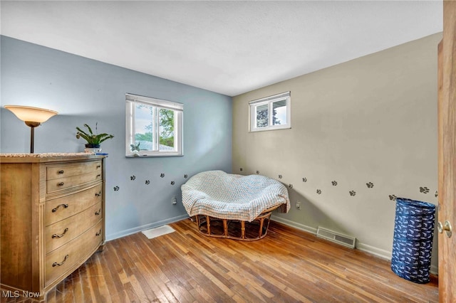 bedroom featuring wood-type flooring and baseboards