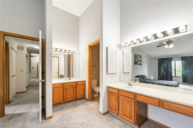 2889 Charing Cross Rd NW, Canton, OH 44708 - full bathroom featuring vanity, high vaulted ceiling, ceiling fan, toilet, and baseboards