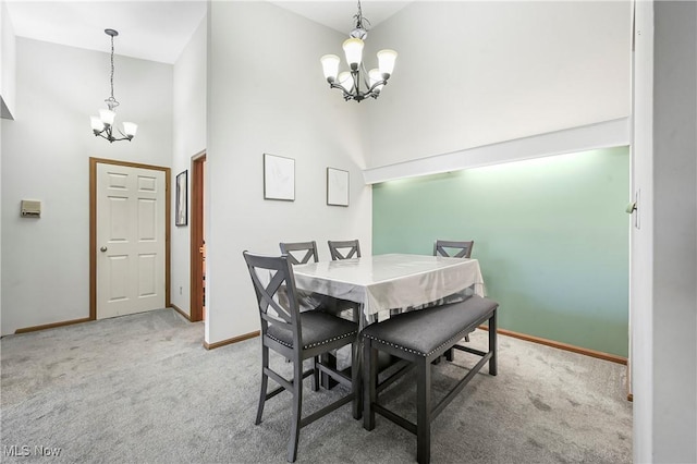 2889 Charing Cross Rd NW, Canton, OH 44708 - dining room with a chandelier, a towering ceiling, carpet floors, and baseboards