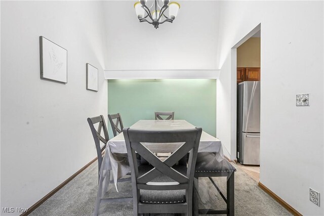 2889 Charing Cross Rd NW, Canton, OH 44708 - dining space with light carpet, a chandelier, and baseboards