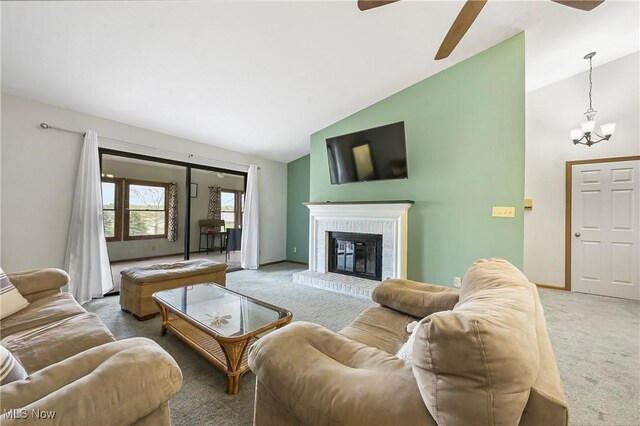 2889 Charing Cross Rd NW, Canton, OH 44708 - carpeted living room featuring vaulted ceiling, a ceiling fan, a chandelier, a brick fireplace, and baseboards