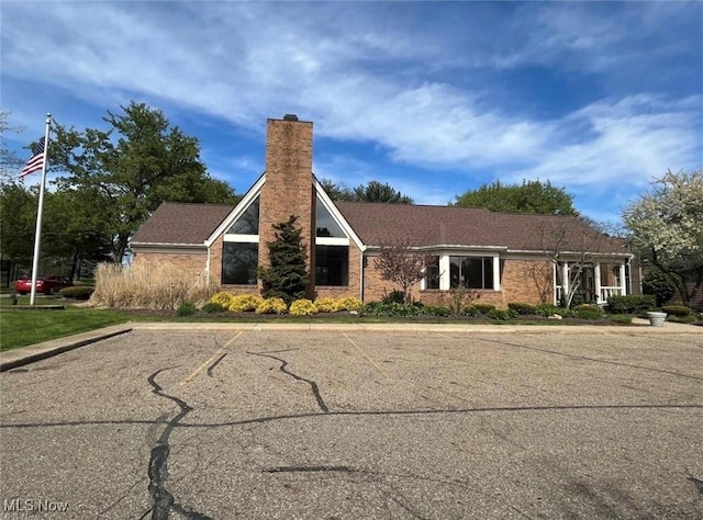 2889 Charing Cross Rd NW, Canton, OH 44708 - view of front facade with a chimney and uncovered parking