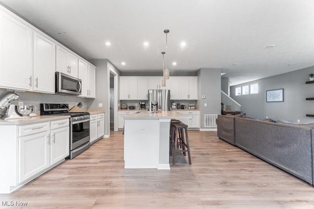1726 Cobham Ln, Wadsworth, OH 44281 - kitchen featuring appliances with stainless steel finishes, open floor plan, white cabinetry, light countertops, and recessed lighting