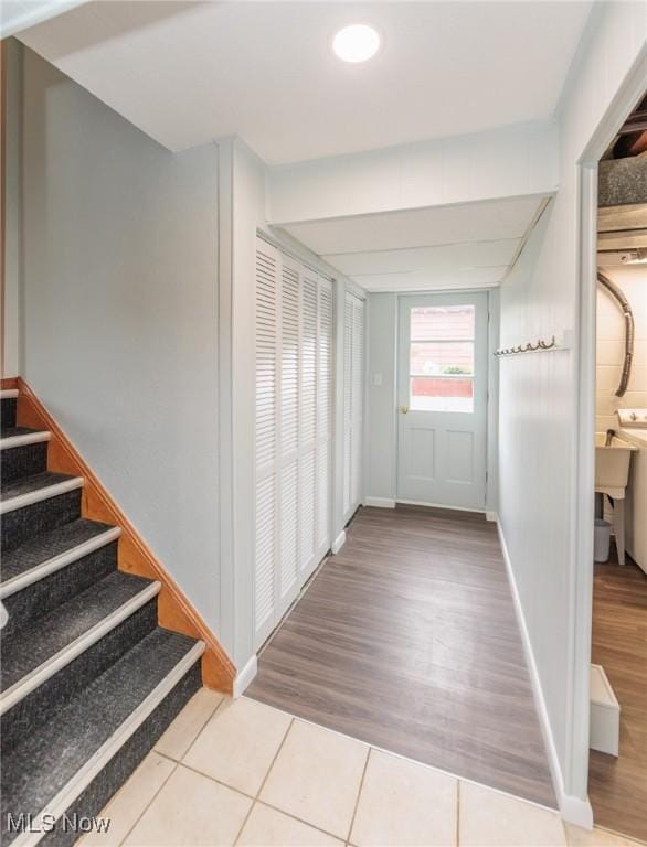 347 Beeler Dr, Berea, OH 44017 - hallway with tile patterned flooring, stairs, and baseboards