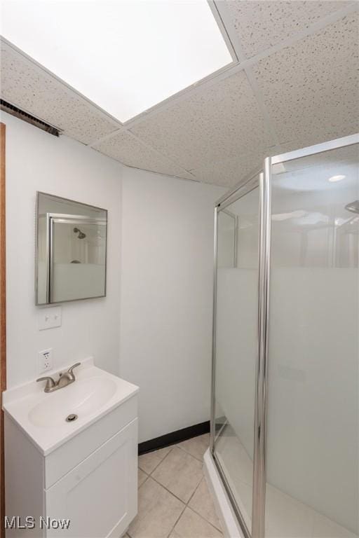 347 Beeler Dr, Berea, OH 44017 - bathroom featuring a drop ceiling, a shower stall, vanity, and tile patterned floors
