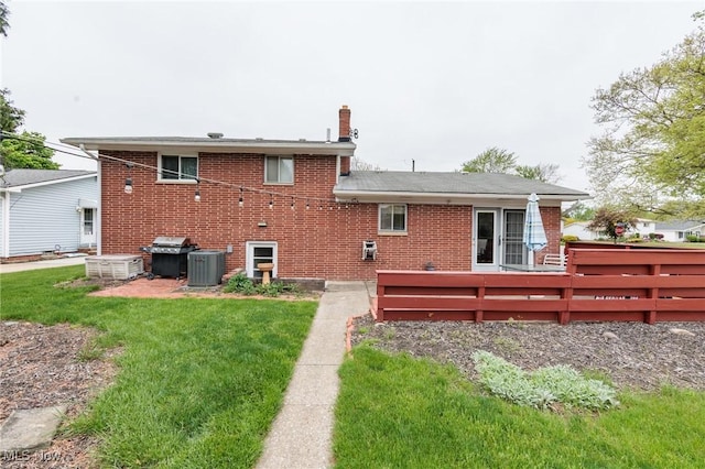 347 Beeler Dr, Berea, OH 44017 - rear view of property featuring brick siding, cooling unit, a yard, and a chimney