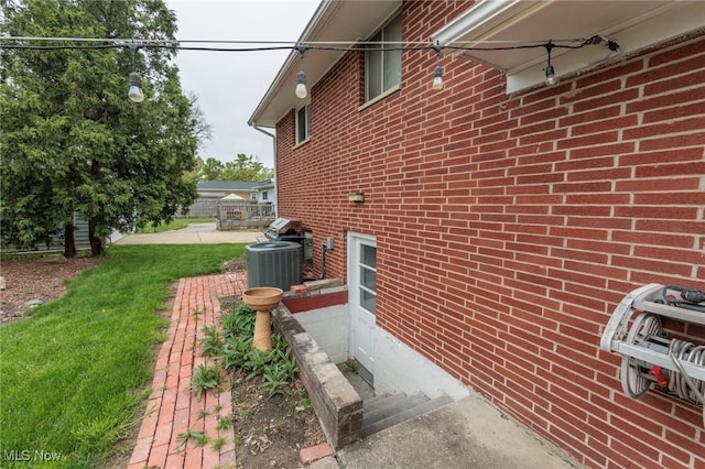 347 Beeler Dr, Berea, OH 44017 - view of side of home with central air condition unit, brick siding, and fence