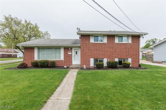 347 Beeler Dr, Berea, OH 44017 - tri-level home featuring a front yard, brick siding, and a shingled roof