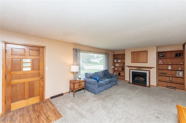 347 Beeler Dr, Berea, OH 44017 - living area featuring a fireplace with flush hearth, baseboards, and light carpet