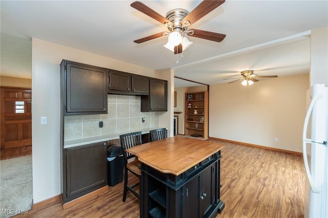 347 Beeler Dr, Berea, OH 44017 - kitchen with freestanding refrigerator, ceiling fan, tasteful backsplash, baseboards, and light wood finished floors
