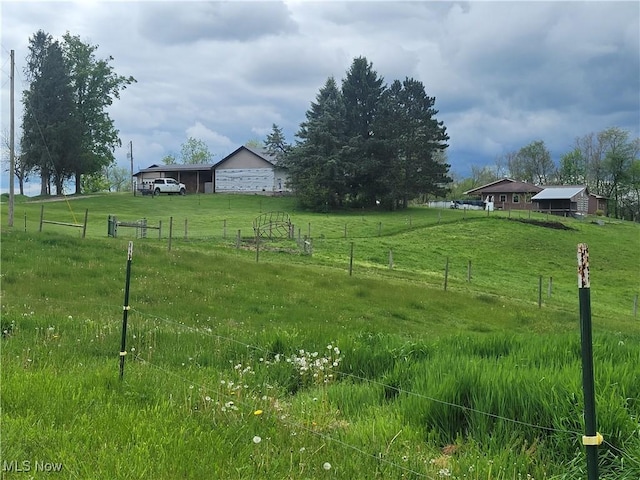 view of yard featuring fence and a view of rural / pastoral area