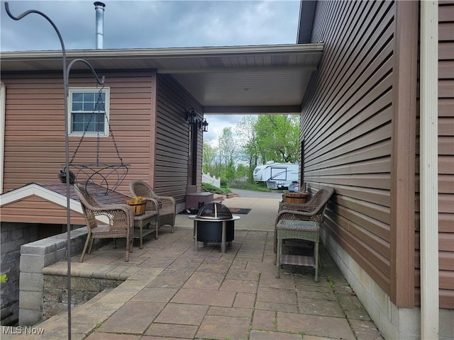 view of patio / terrace with an outdoor fire pit