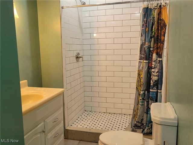 full bath with toilet, a stall shower, and vanity