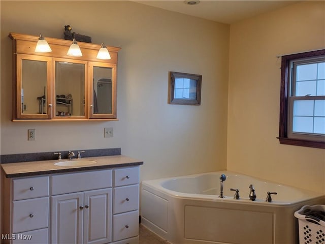 bathroom with vanity and a garden tub
