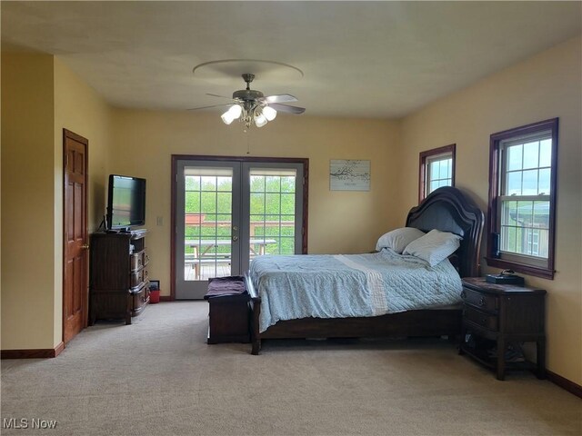 bedroom with access to outside, french doors, light carpet, baseboards, and a ceiling fan