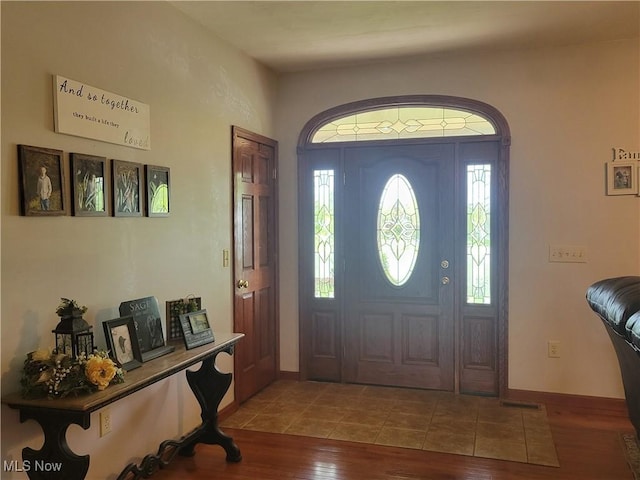 entrance foyer featuring wood finished floors and baseboards