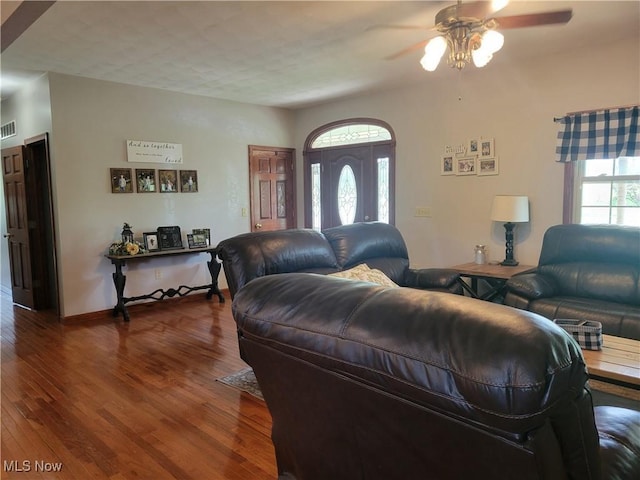 living room with a ceiling fan and wood finished floors
