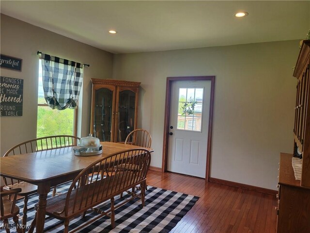 dining room featuring hardwood / wood-style flooring, baseboards, and recessed lighting
