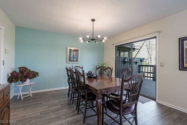 613-3 Fairington Oval, Aurora, OH 44202 - dining area featuring a chandelier, dark wood-type flooring, and baseboards