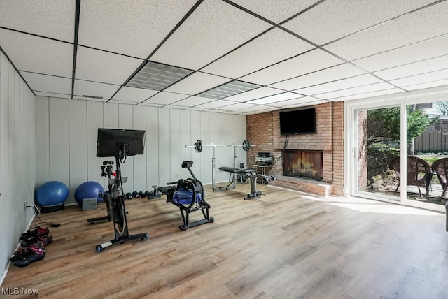 613-3 Fairington Oval, Aurora, OH 44202 - workout room featuring a fireplace, wood finished floors, and a drop ceiling