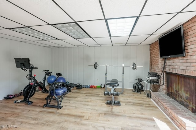 613-3 Fairington Oval, Aurora, OH 44202 - exercise room with a fireplace, wood finished floors, and a drop ceiling