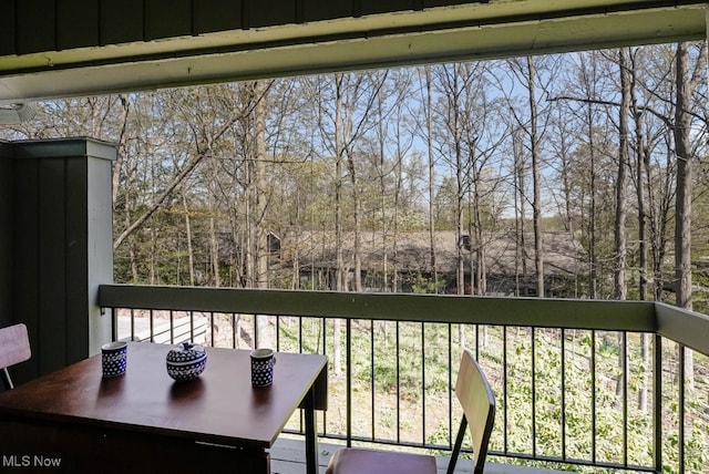 613-3 Fairington Oval, Aurora, OH 44202 - balcony featuring outdoor dining space and view of wooded area