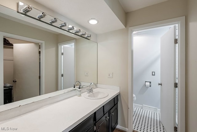 613-3 Fairington Oval, Aurora, OH 44202 - bathroom with baseboards, toilet, vanity, and tile patterned floors
