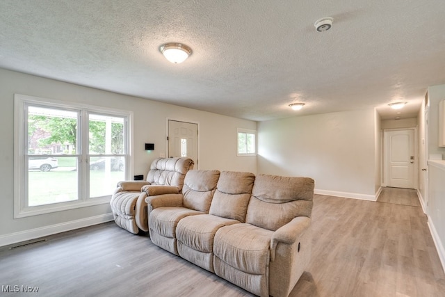 24560 Eldridge Blvd, Bedford Heights, OH 44146 - living room with a textured ceiling, light wood-style flooring, and baseboards