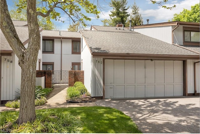 760 Spafford Oval, Sagamore Hills, OH 44067 - multi unit property featuring roof with shingles, fence, a garage, a gate, and driveway