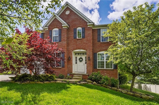georgian-style home featuring brick siding