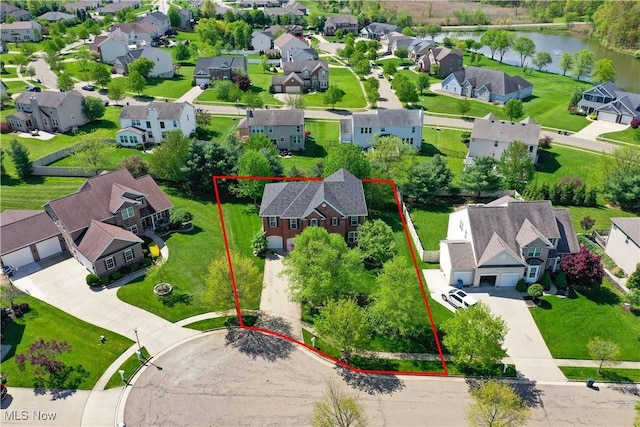 aerial view of residential area featuring a nearby body of water and property boundaries highlighted