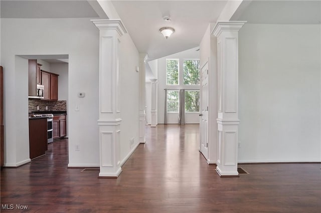 hallway with decorative columns, dark wood-style flooring, and baseboards