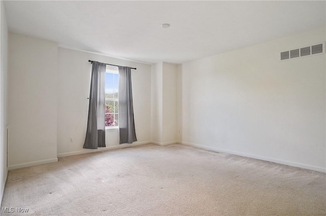 carpeted empty room with baseboards