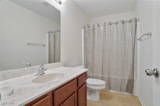 bathroom featuring shower / tub combo, toilet, vanity, and tile patterned floors