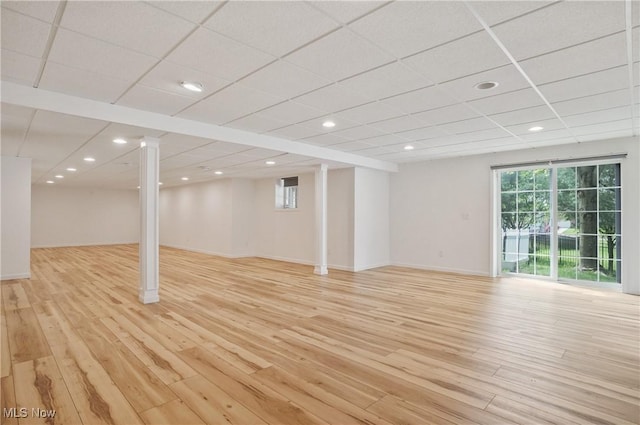 below grade area featuring light wood-style floors, recessed lighting, and baseboards