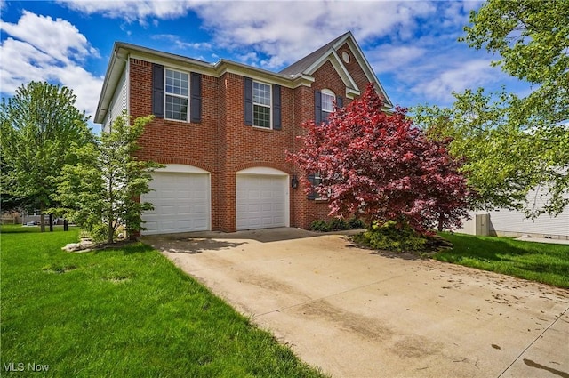 view of front of property featuring driveway, an attached garage, a front yard, and brick siding