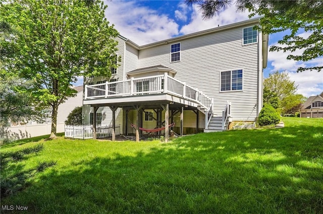 back of property with a wooden deck and stairway