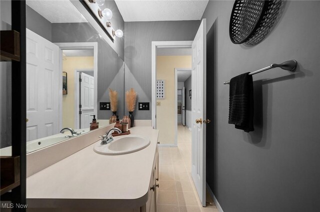 16538 S White Oaks Dr, Strongsville, OH 44136 - bathroom with tile patterned flooring, vanity, and baseboards
