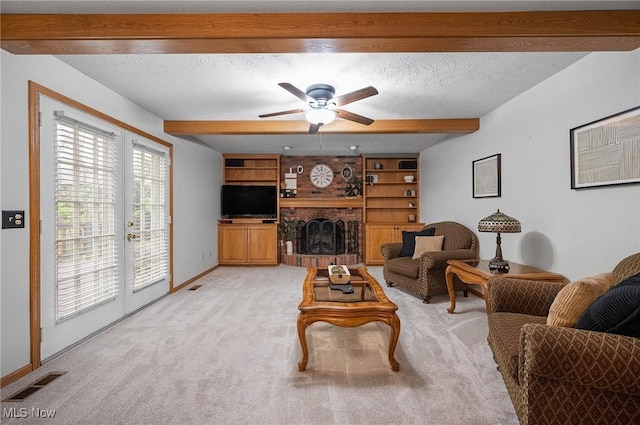16538 S White Oaks Dr, Strongsville, OH 44136 - living room with a ceiling fan, light carpet, a textured ceiling, beamed ceiling, and a brick fireplace