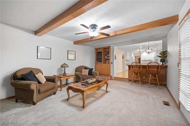 16538 S White Oaks Dr, Strongsville, OH 44136 - living area with beamed ceiling, light carpet, baseboards, and a ceiling fan